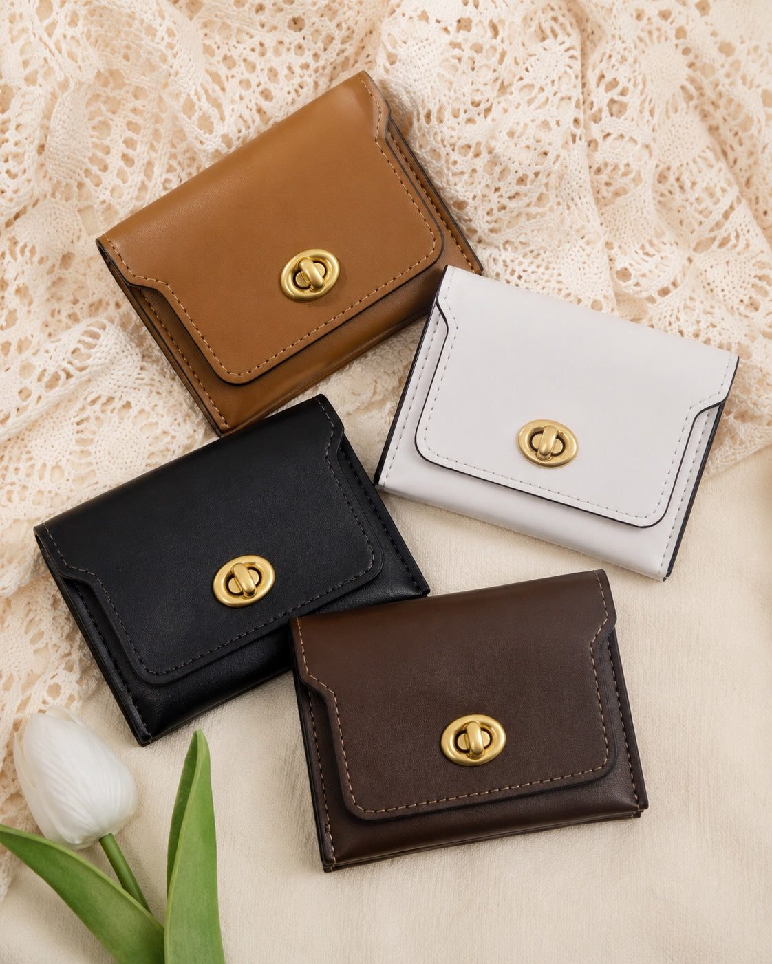 The Turnlock Wallet in Cognac, Ivory, Black and Chocolate